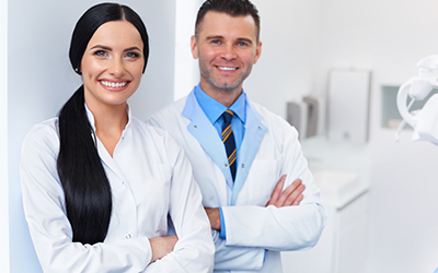 A female and male doctor smiling
