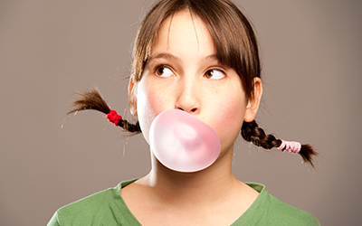 A child blowing bubble gum