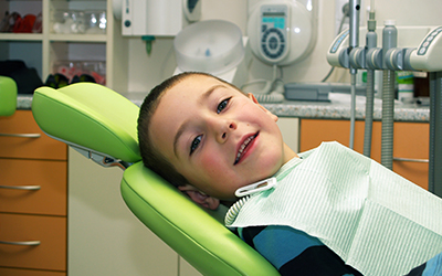 A young boy sitting in a dental chair