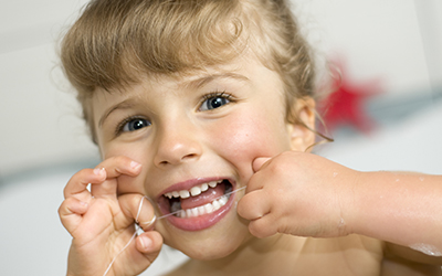 Young girl flossing