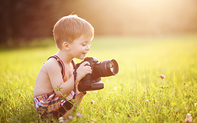 Child with a large camera