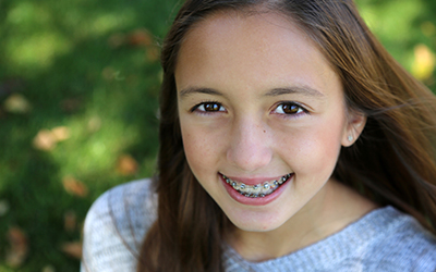 Child with smiling with braces on