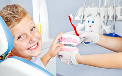 Happy young child smiling in a dental chair