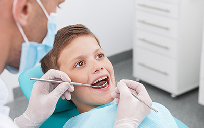 A young boy having his teeth worked on
