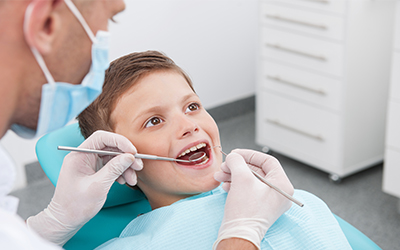 A young boy getting his teeth cleaned