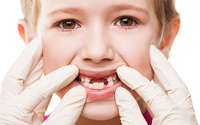 Dentist examining a childs teeth