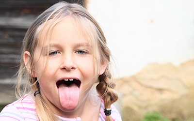 A young girl sticking her tongue out