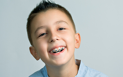 A young boy smiling with braces