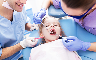 A young girl having dental work done